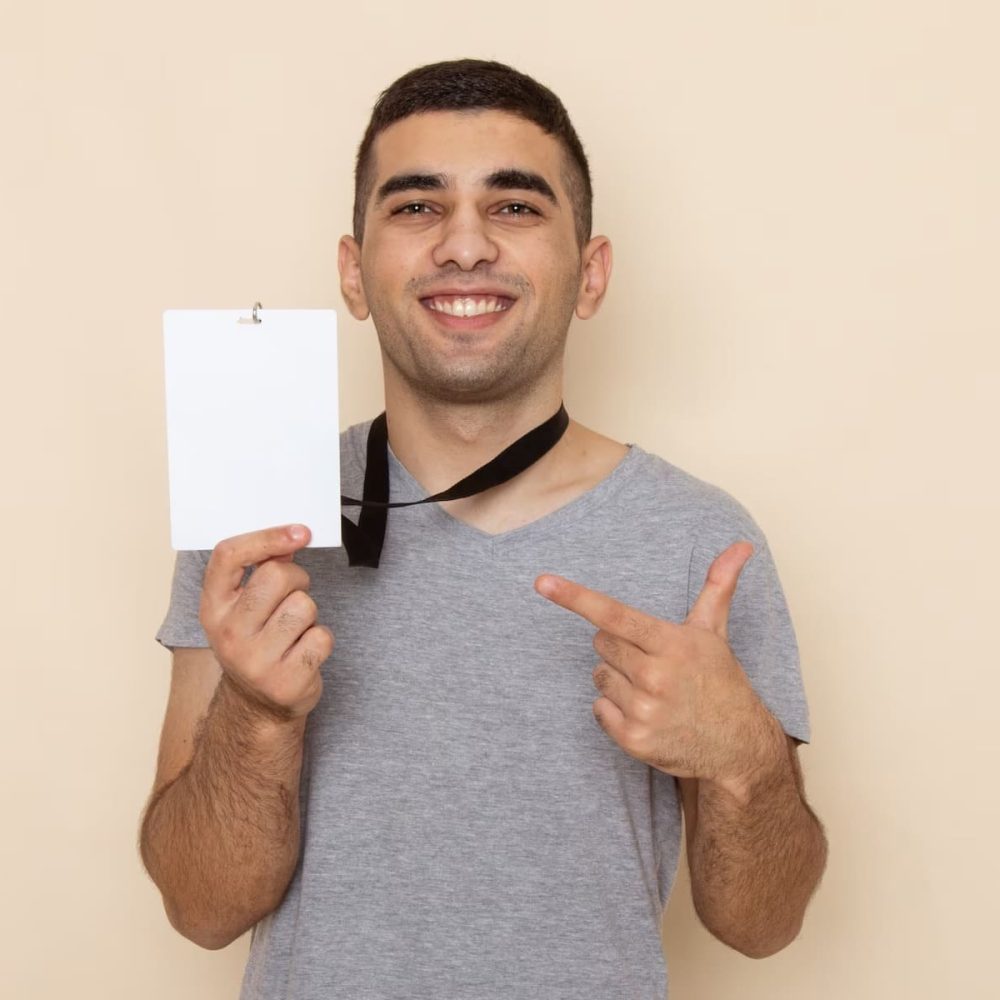 front-view-young-male-grey-t-shirt-holding-identity-card-with-smile-beige_140725-21356_3_11zon